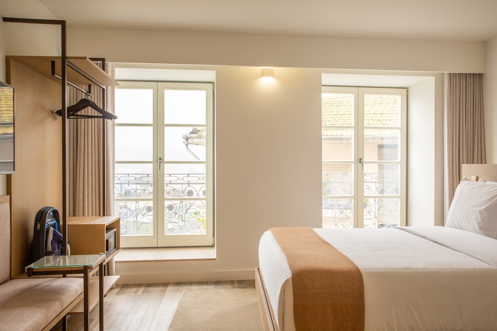 a hotel room with a large bed and a window