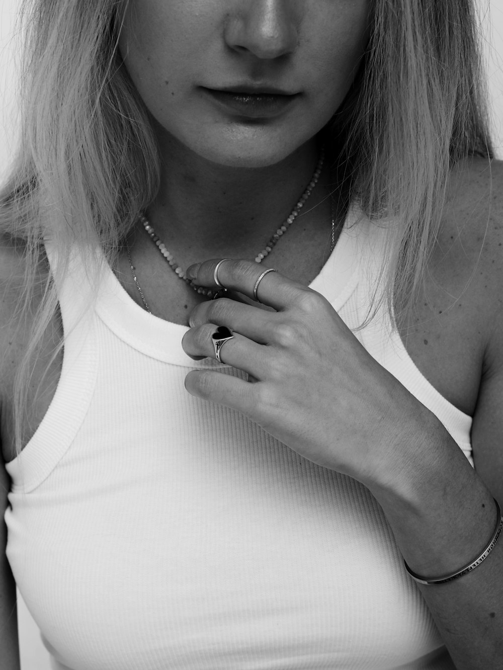 a black and white photo of a woman in a tank top