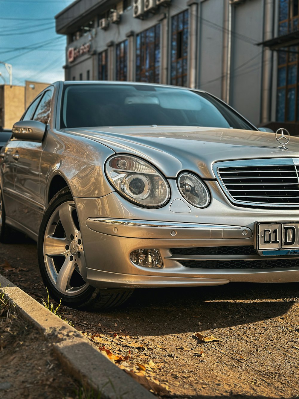 a silver car parked on the side of the road