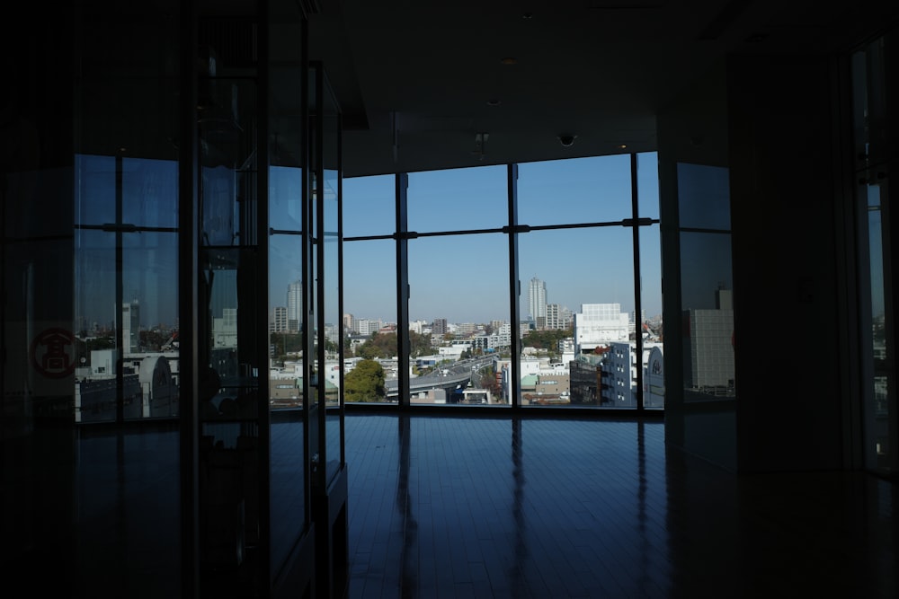 a room with large windows and a view of a city
