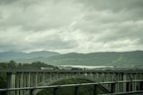 A Gobind General Transport LLC truck crossing a bridge, with mountains in the background.