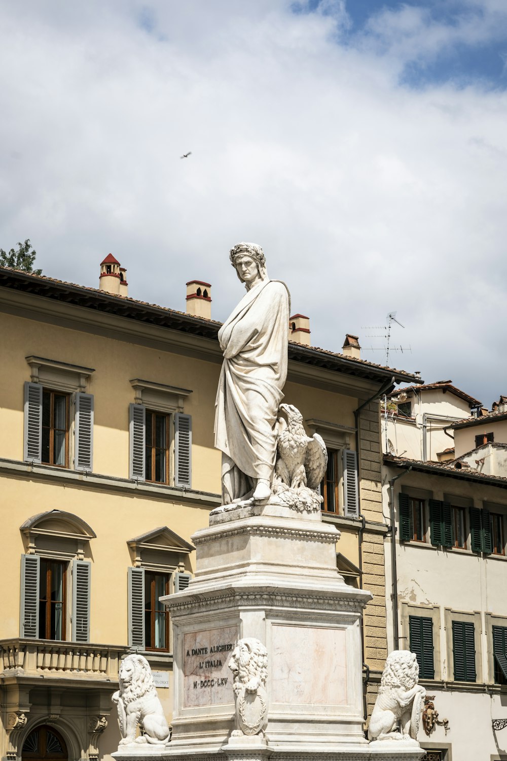 a statue of a man with a dog in front of a building