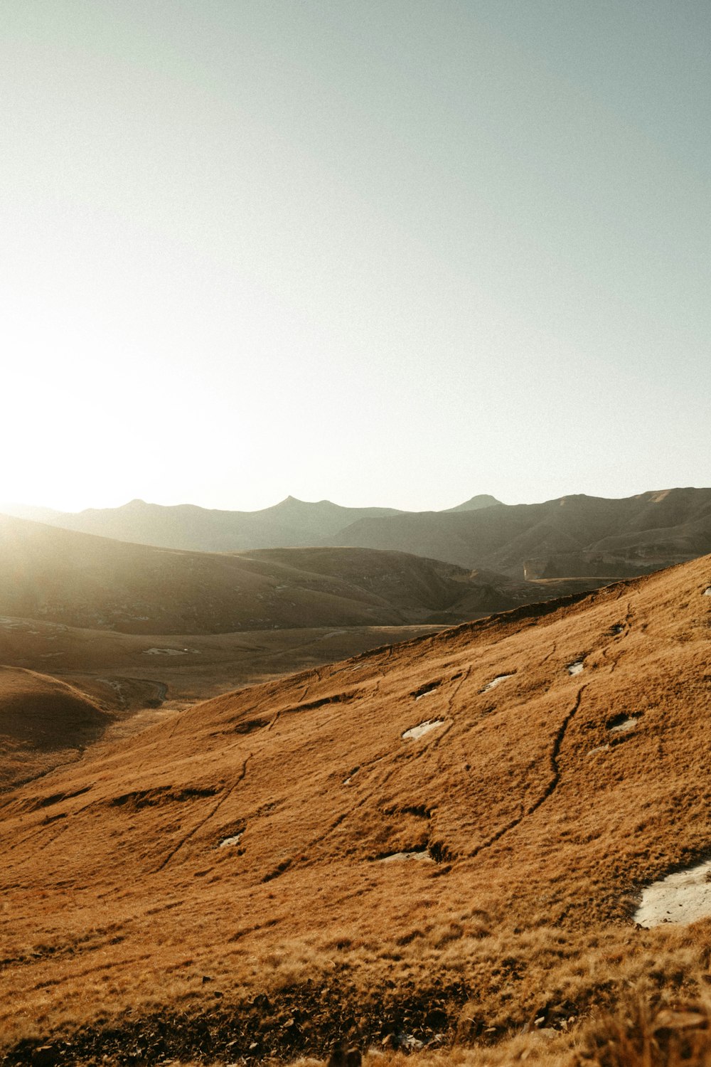 a man riding a horse down a dirt road