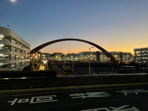 Modern infrastructures including bridges and public buildings at sunset.