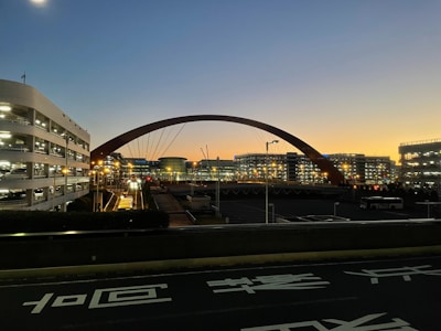 A sleek metro viaduct stretching across an urban skyline at dawn.