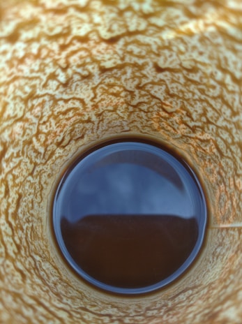 Close-up of a pastel-colored Magic Cup with glitter swirling inside like a snow globe.