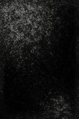 A dark image with scattered small points of light that resemble stars or distant galaxies in a night sky. The light is concentrated in clusters, with one large area at the top and a smaller cluster near the bottom. The surrounding area is mostly dark, enhancing the contrast with the bright points.