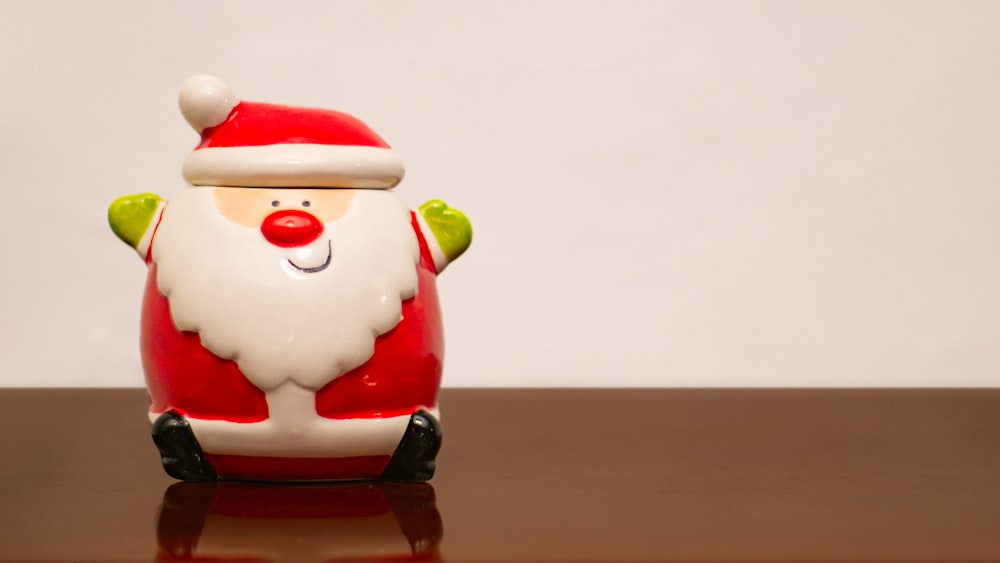 a santa clause figurine sitting on top of a table