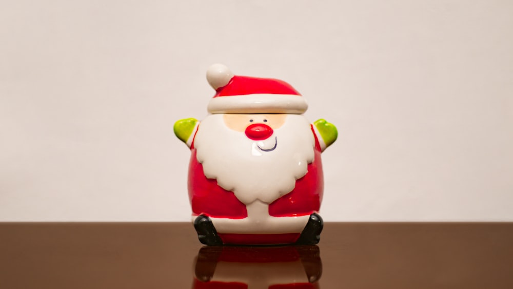 a santa clause figurine sitting on top of a table