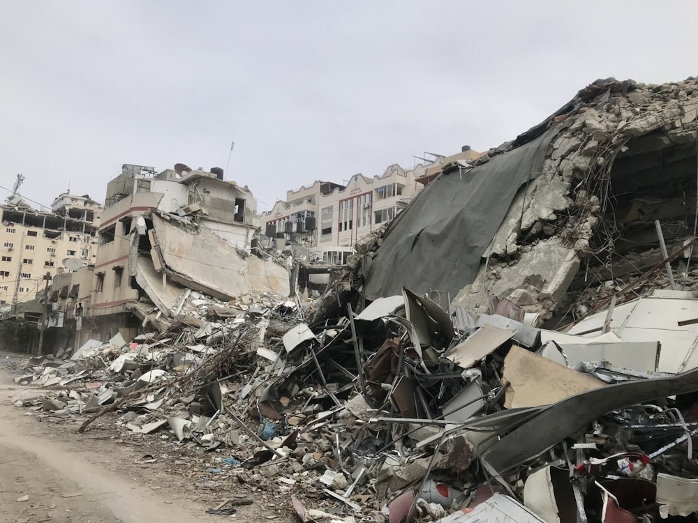 a large pile of rubble next to a dirt road