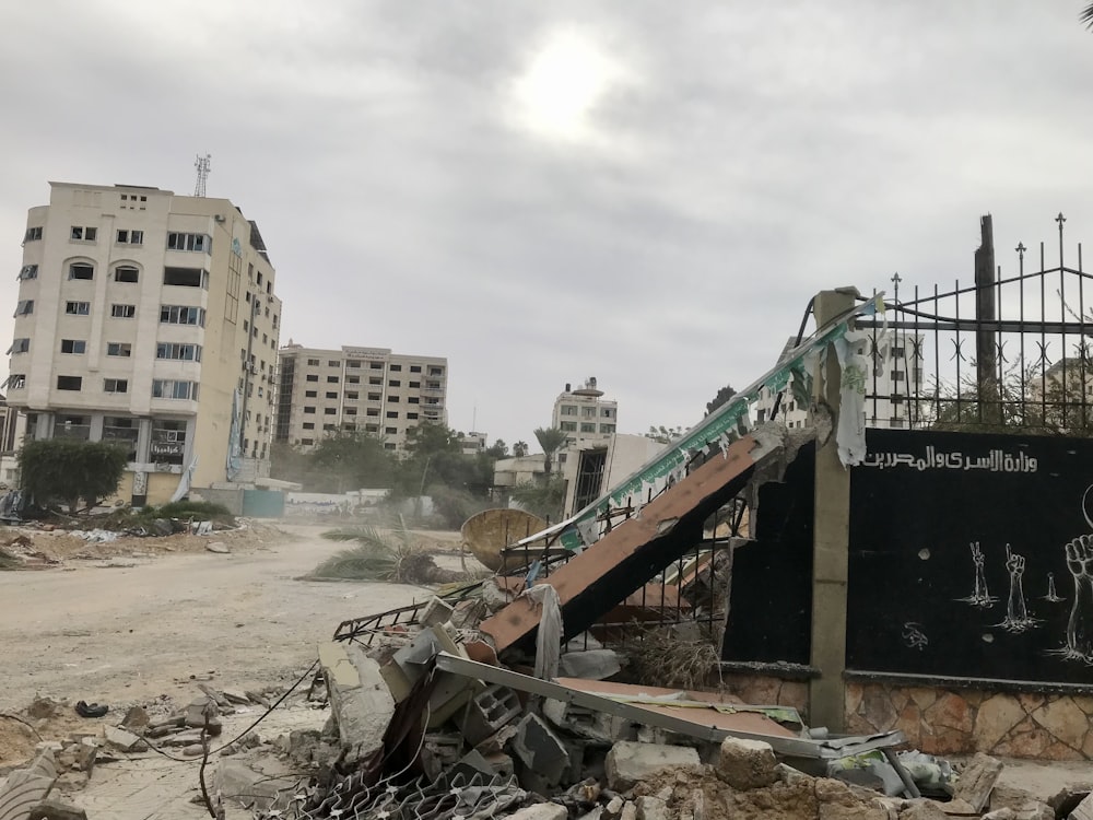 a pile of rubble next to a building with graffiti on it