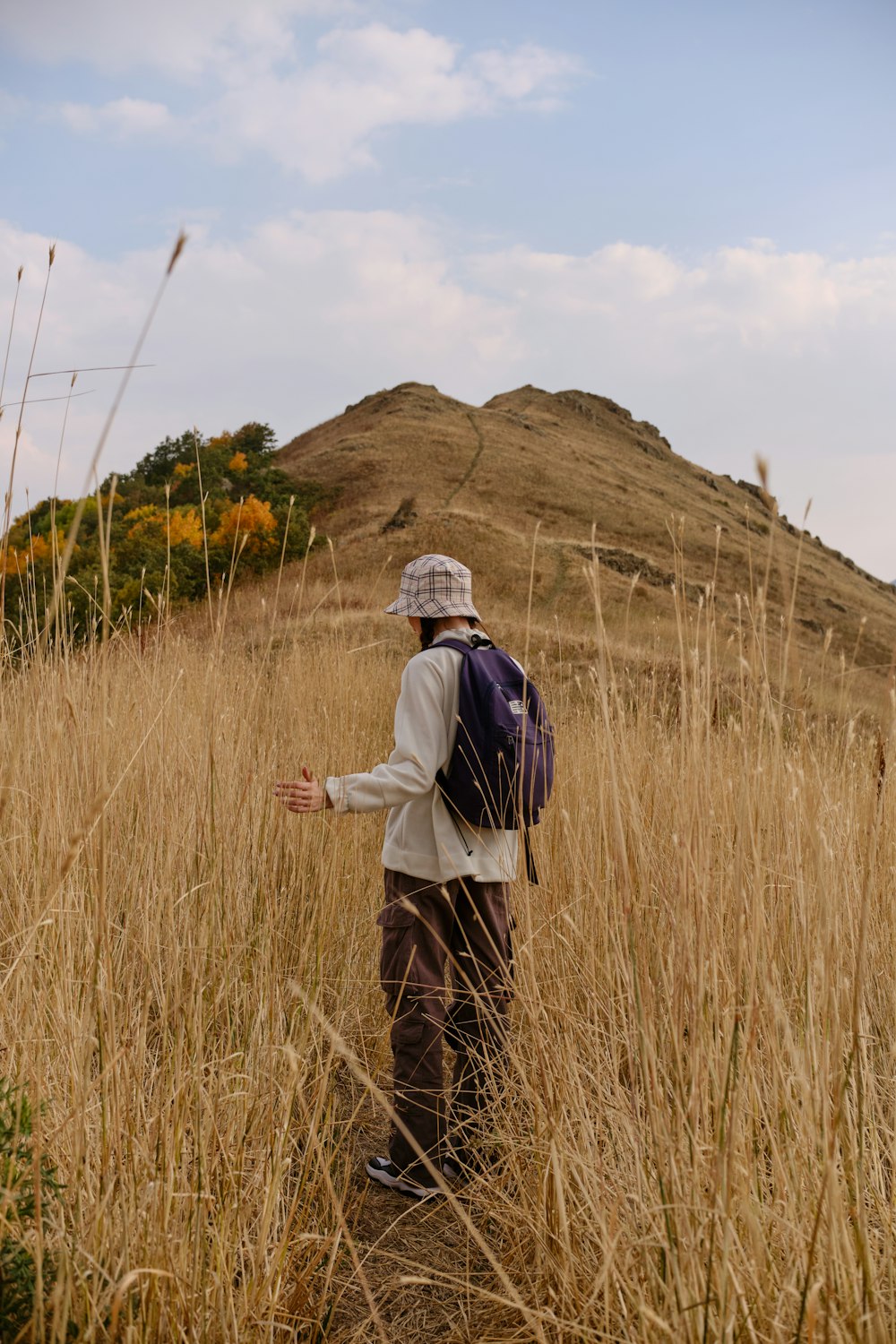 a person standing in a field of tall grass