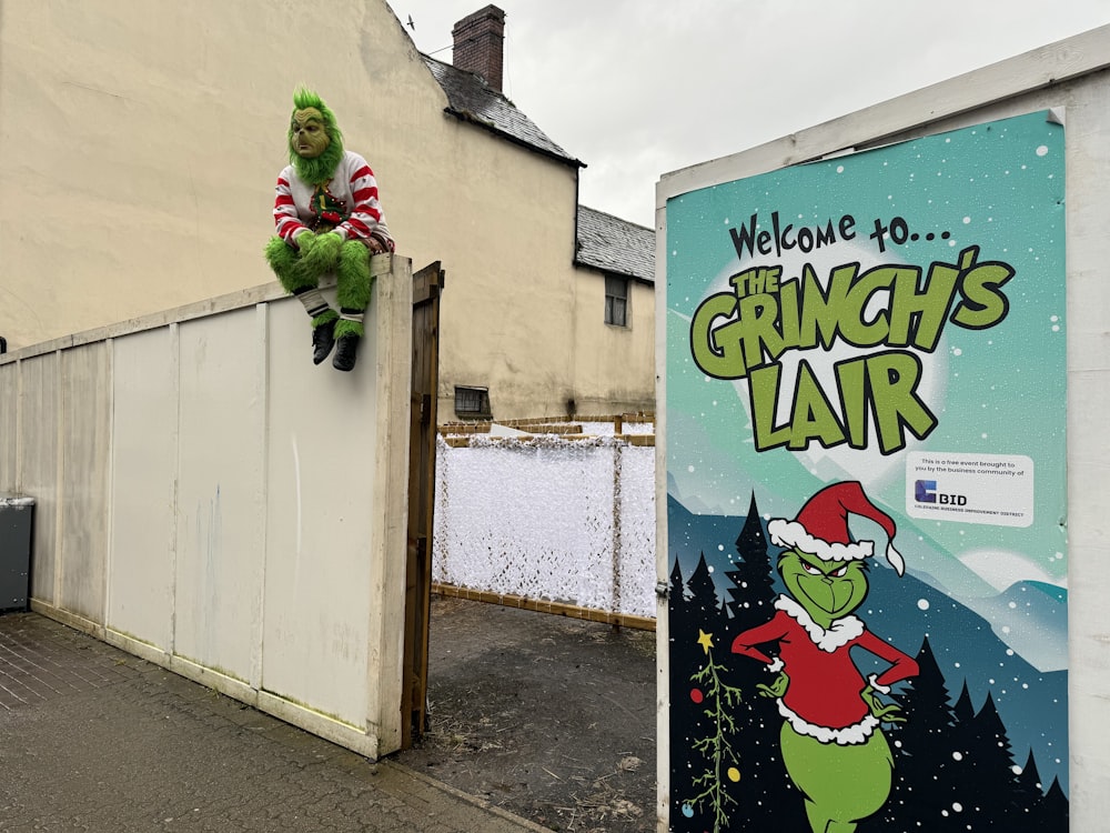 a grinch's fair sign with a grinch on top of it