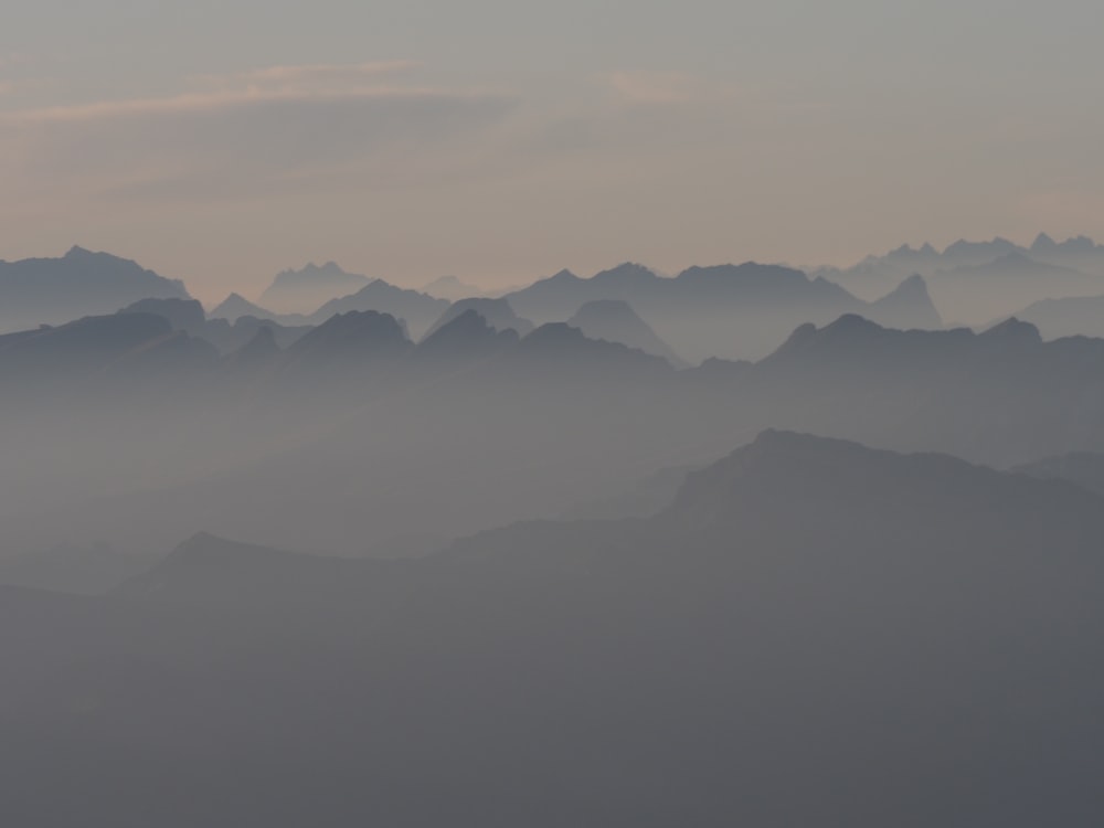 a view of a mountain range in the fog