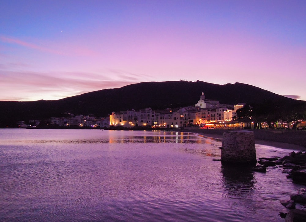 a body of water with a city in the background