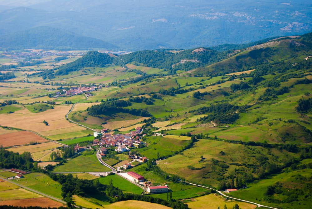 an aerial view of a village in a valley