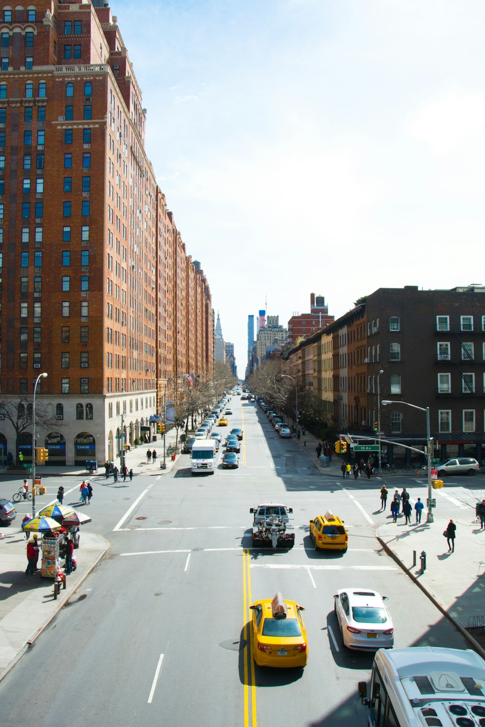 a city street filled with lots of traffic and tall buildings