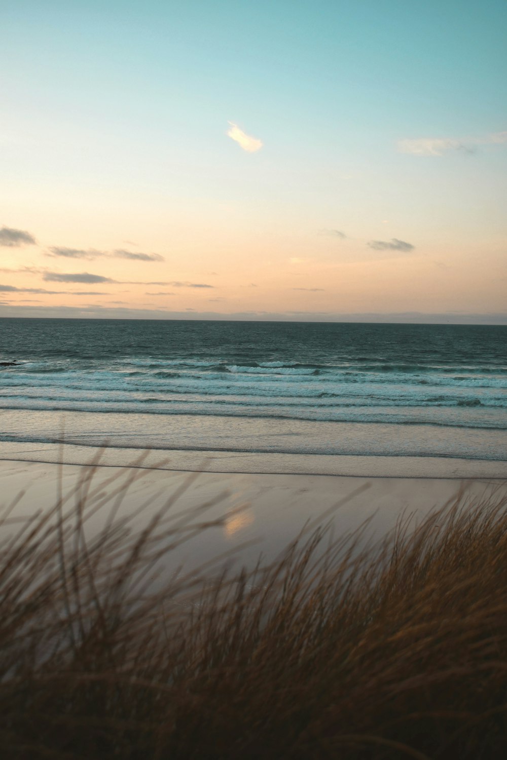 a view of a beach with a boat in the distance