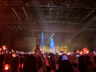 Nighttime shot of a small cozy venue with stage lights glowing.