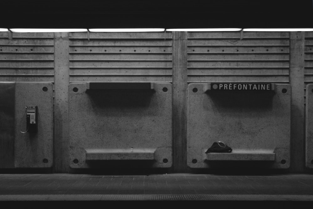 a black and white photo of a row of urinals