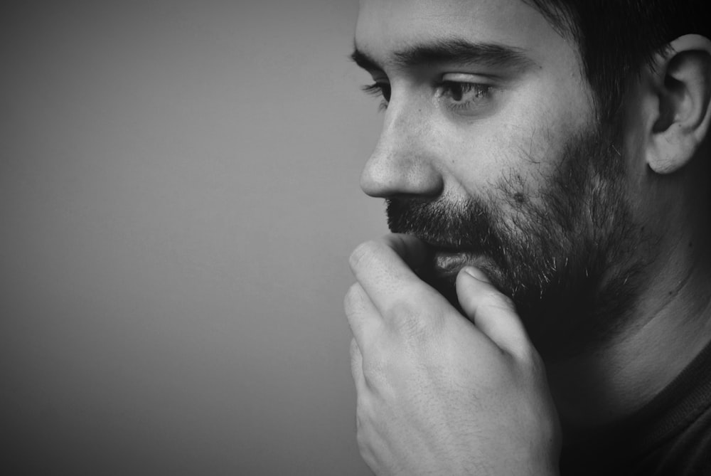 a black and white photo of a man with a beard