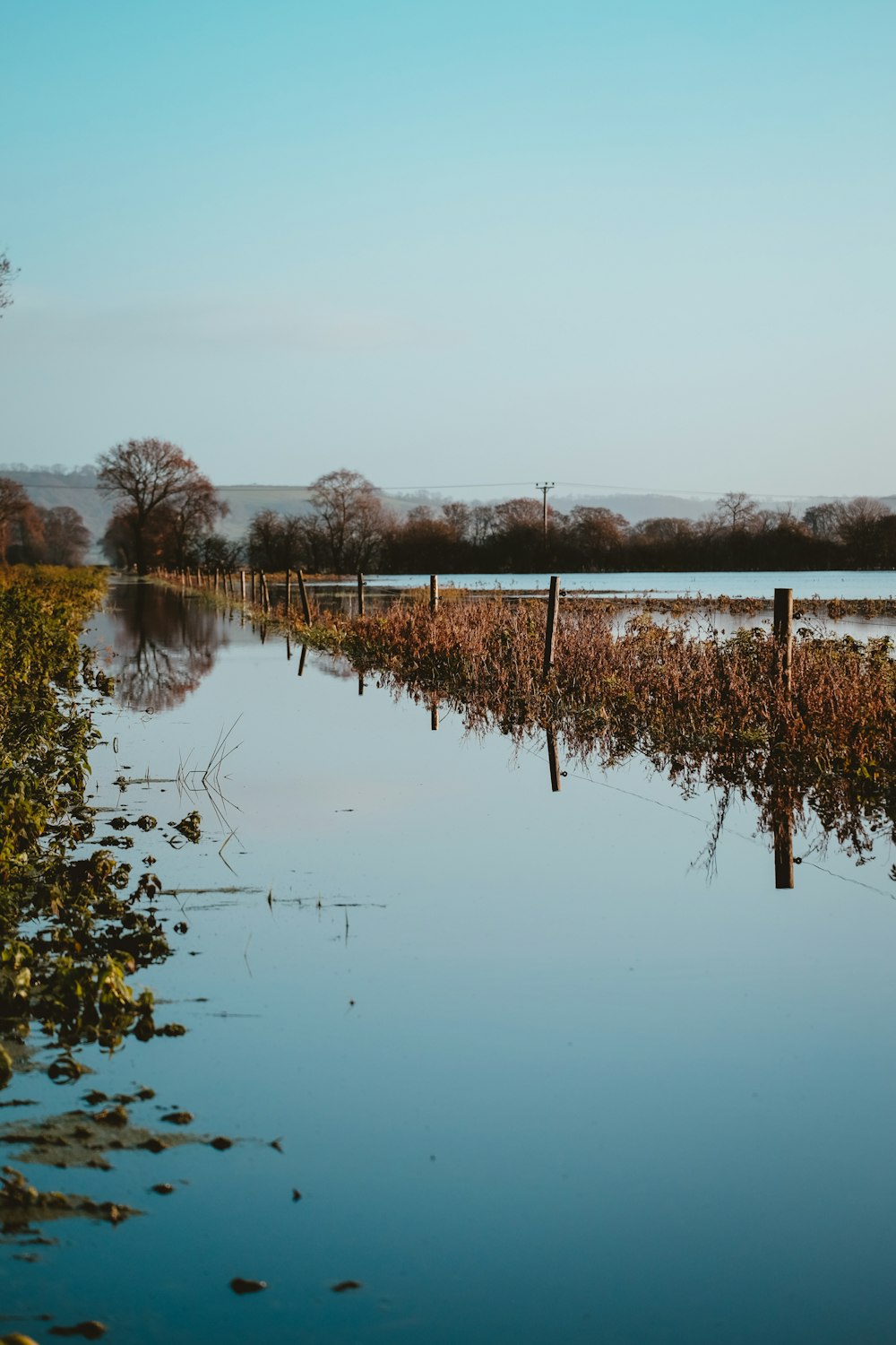 a body of water with a fence in the middle of it