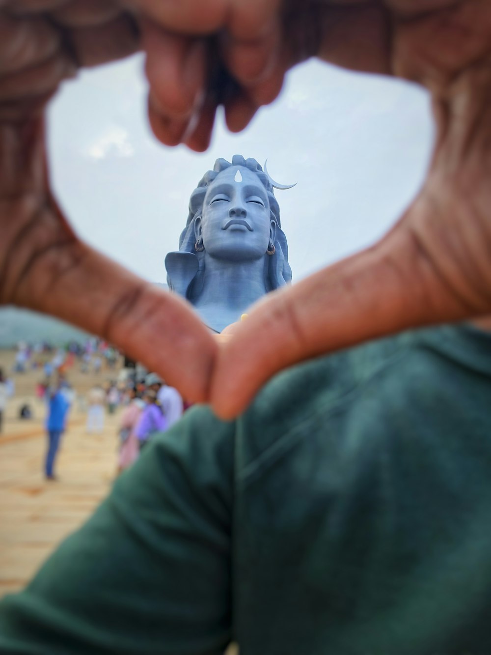 a person making a heart shape with their hands