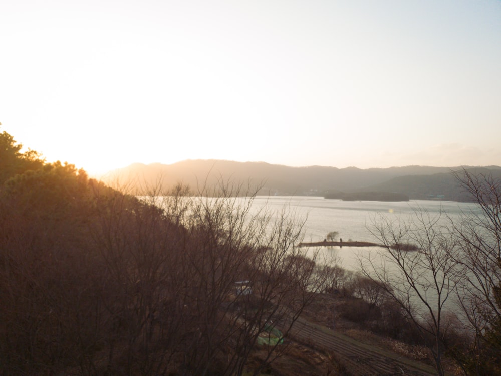 the sun is setting over a body of water