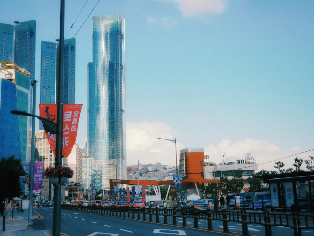 a city street with tall buildings in the background