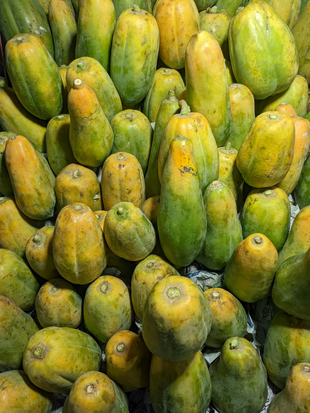 a pile of mangoes sitting on top of each other