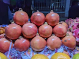 Sunlit baskets brimming with juicy pomegranates ready for delivery.