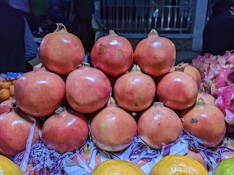 Vibrant red pomegranates arranged neatly in boxes ready for distribution.