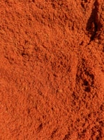 a close up of a pile of red dirt