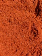 a close up of a pile of red dirt