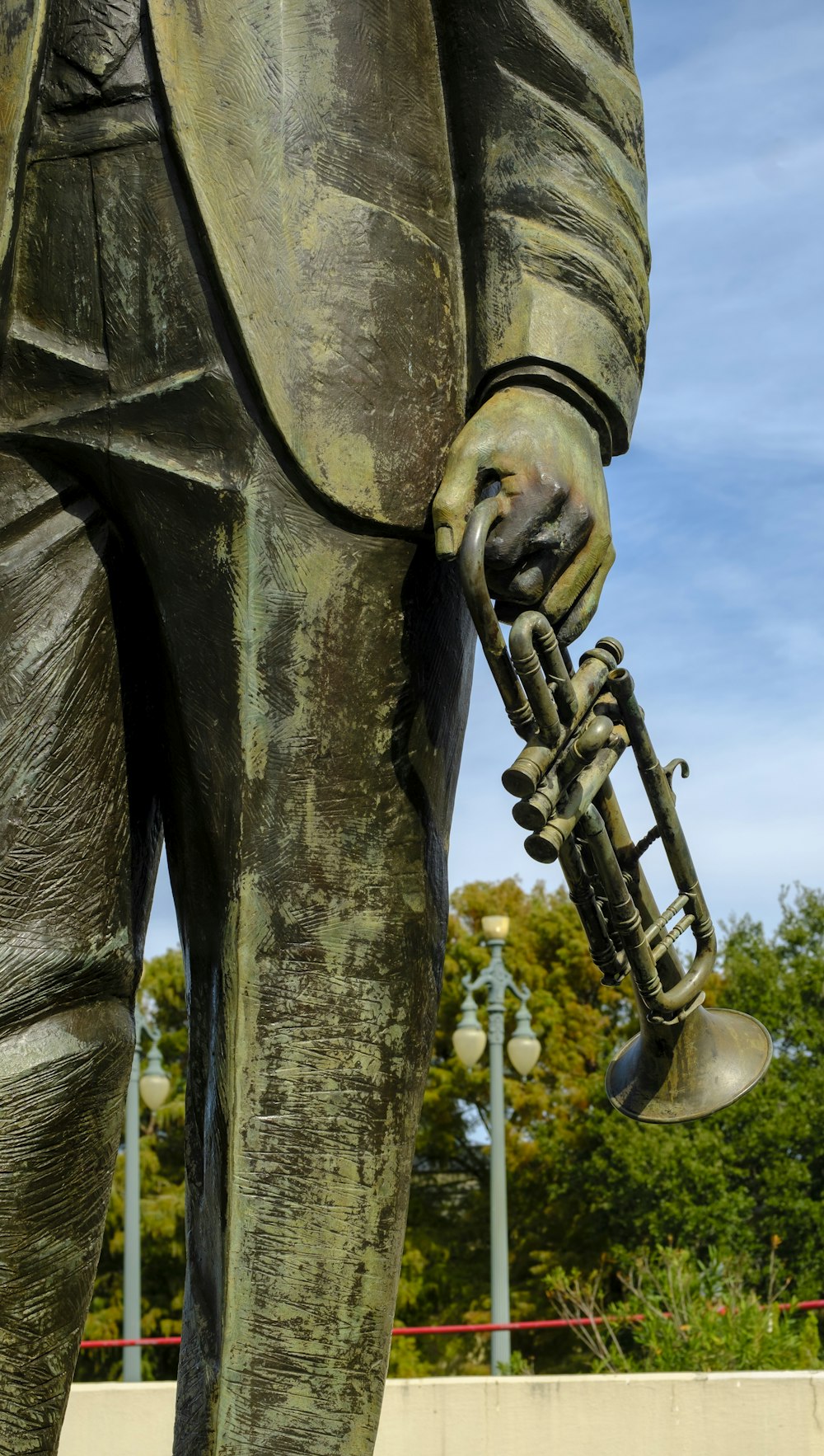 a statue of a man holding a trumpet