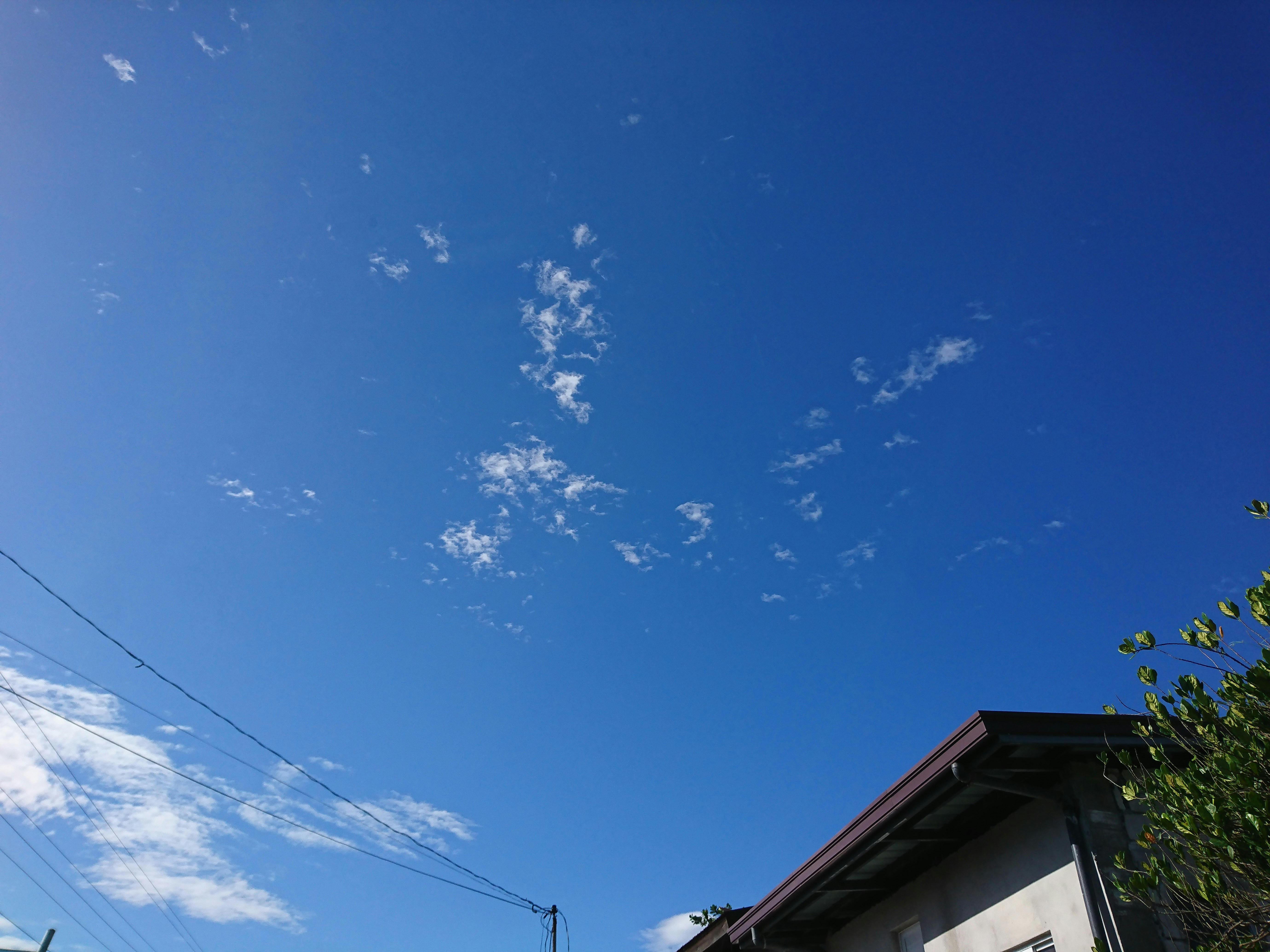 a clear blue sky with some clouds in the background