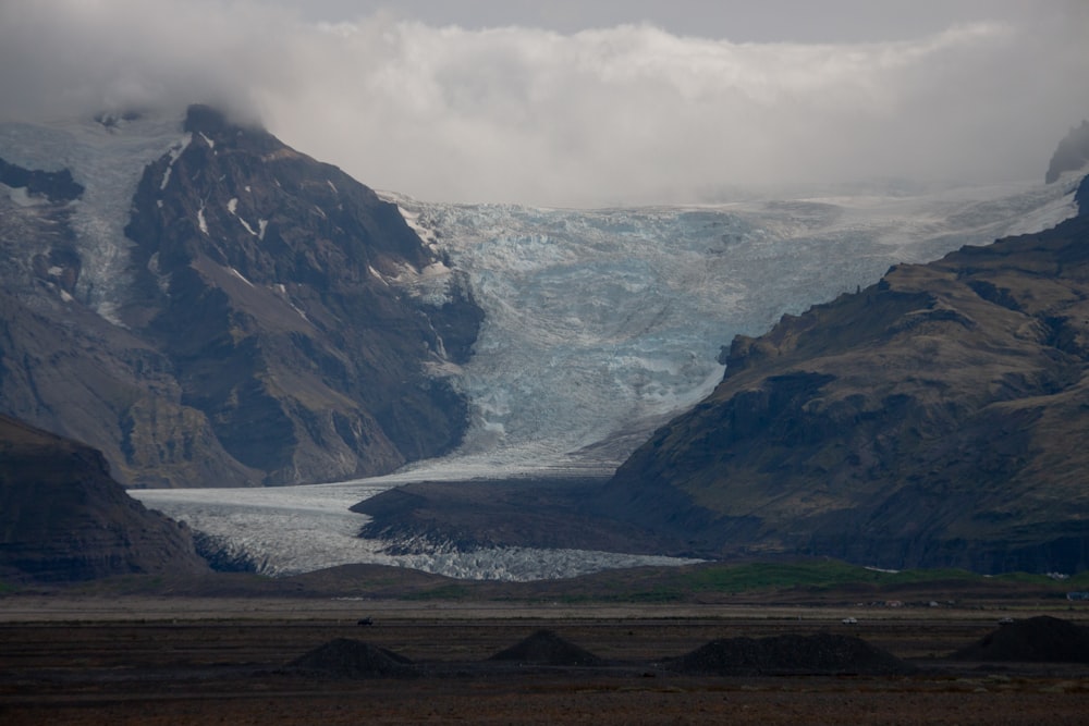 a large glacier in the middle of a mountain range