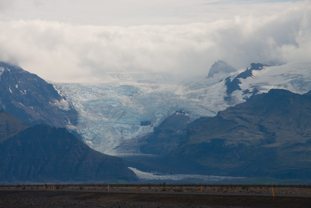 a mountain range with a glacier in the distance
