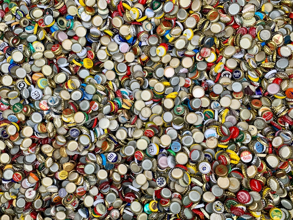 a large amount of bottle caps are stacked on top of each other