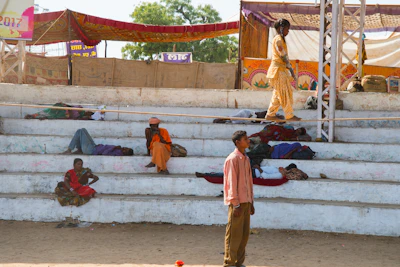 Pilgrims resting peacefully in shaded areas after a day of rituals.