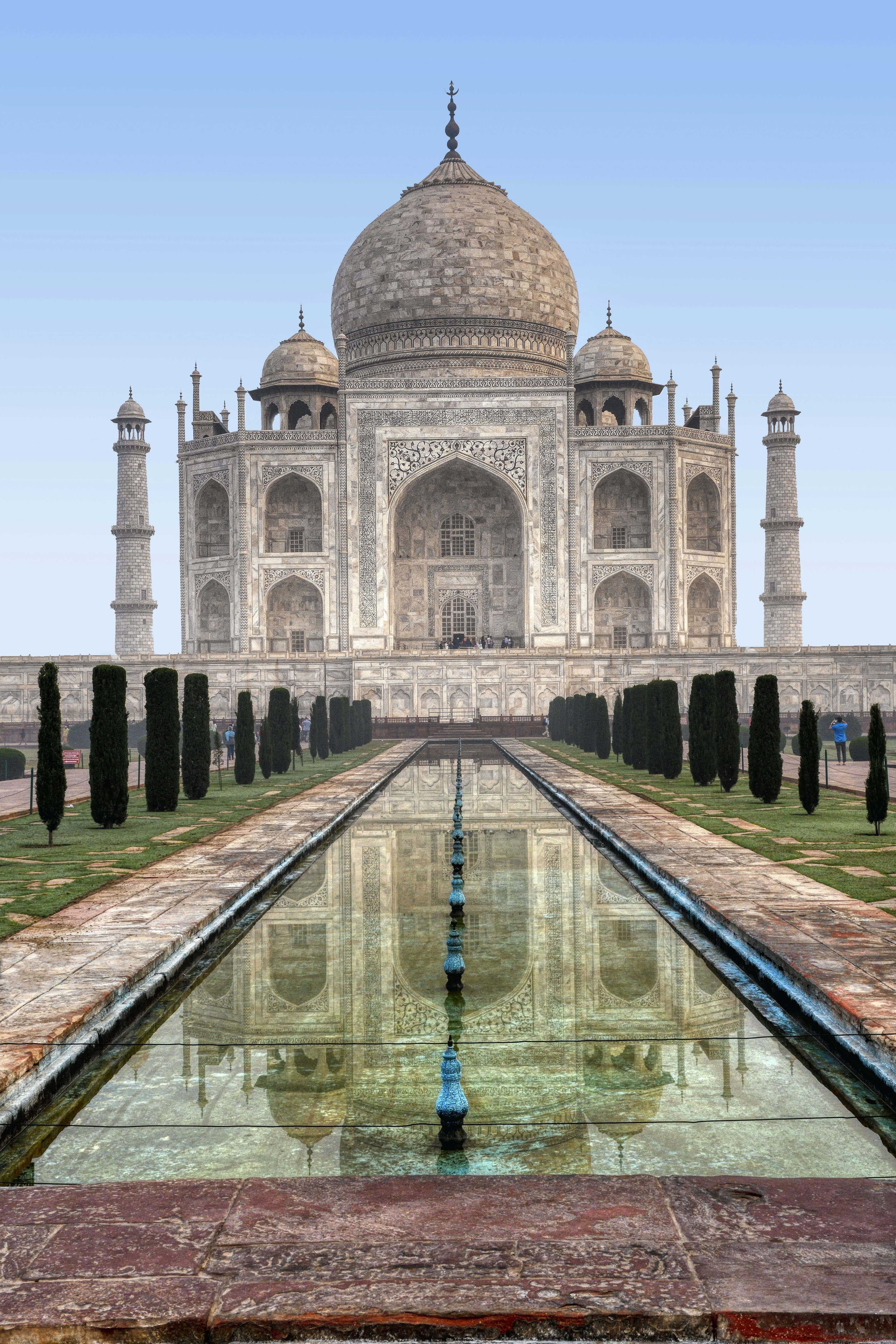 a large building with a long pool of water in front of it