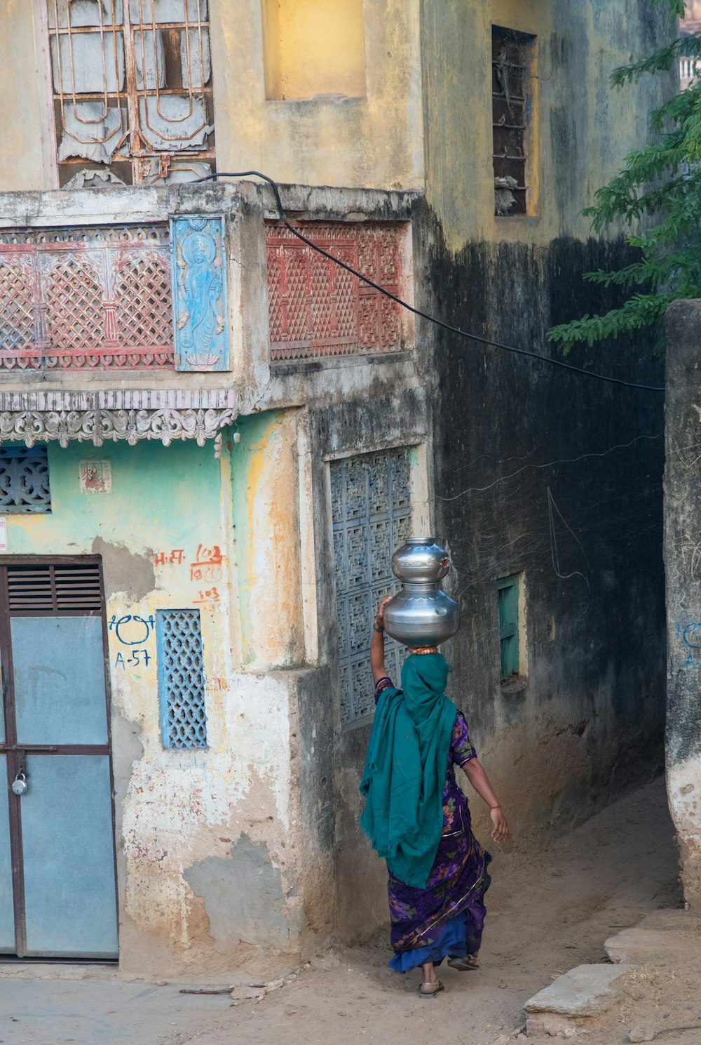 a woman walking down a street in front of a building