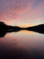 A vibrant sunset over a quiet lake, reflecting colors of transformation and peace.