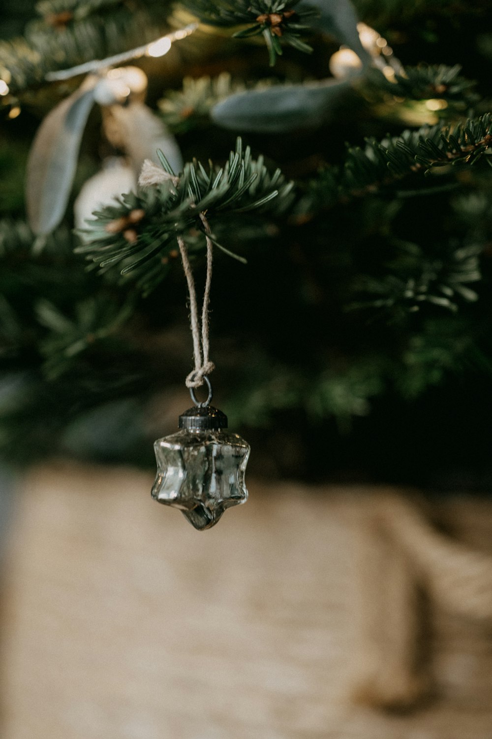 a glass ornament hanging from a christmas tree