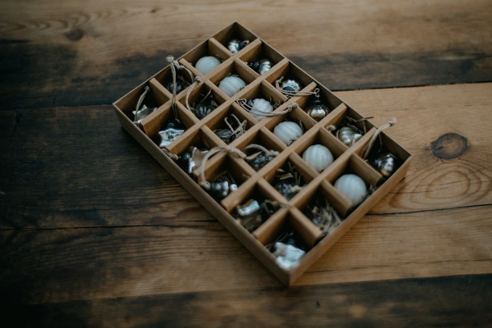 a box filled with ornaments on top of a wooden floor
