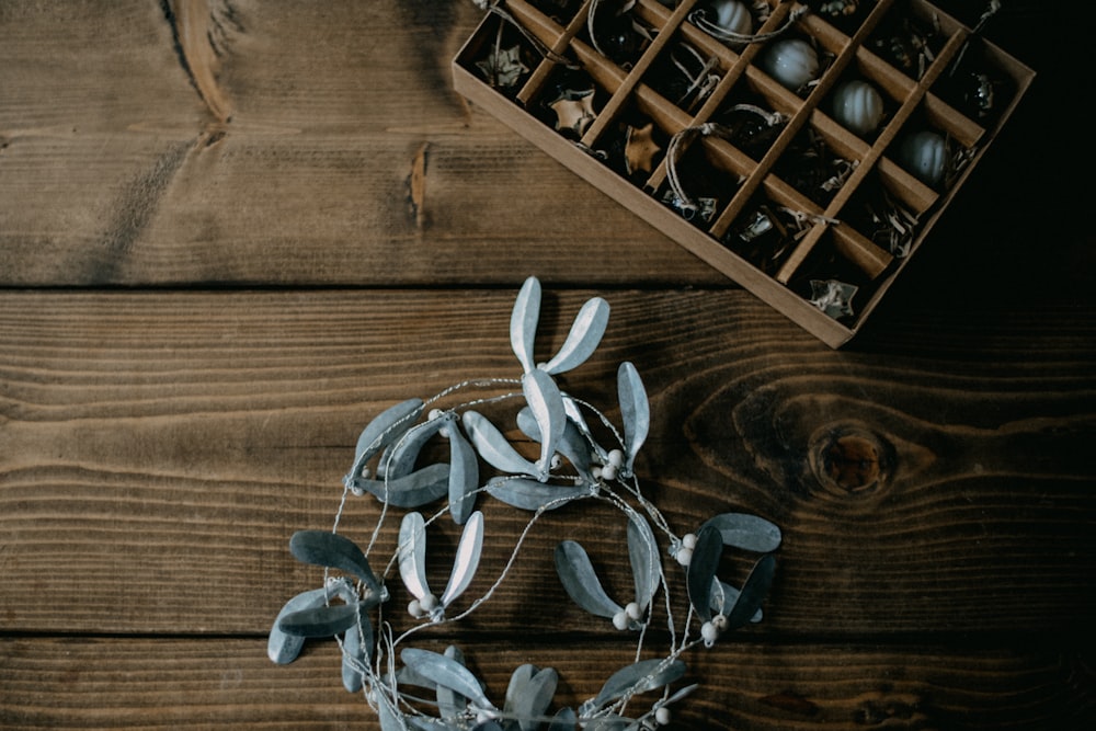 a box of ornaments sits on a wooden table