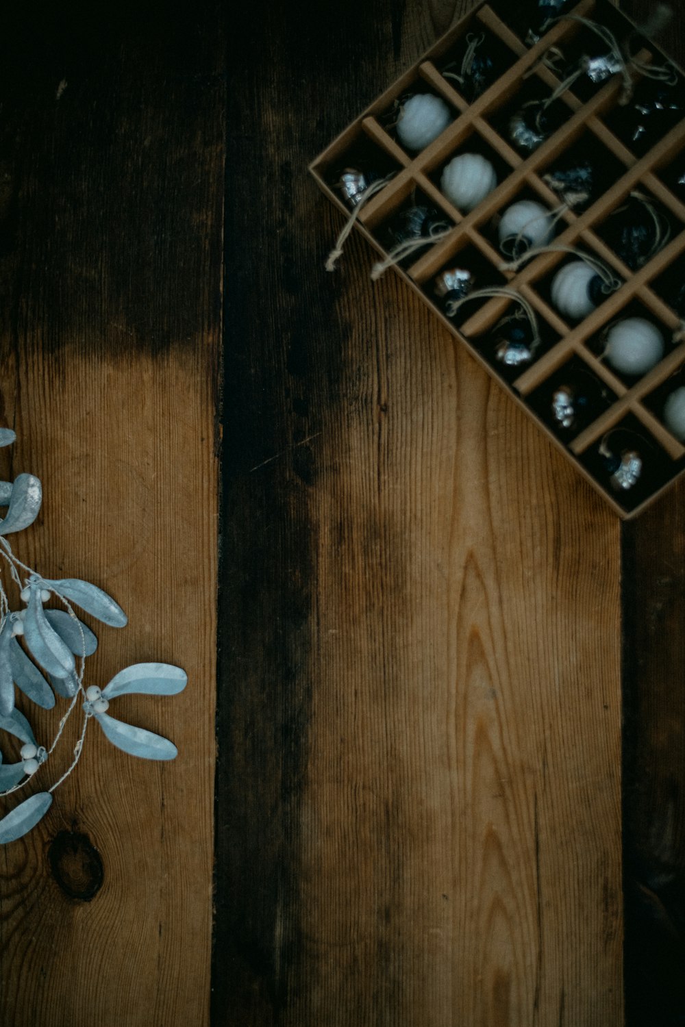 a wooden table topped with a vase filled with white flowers