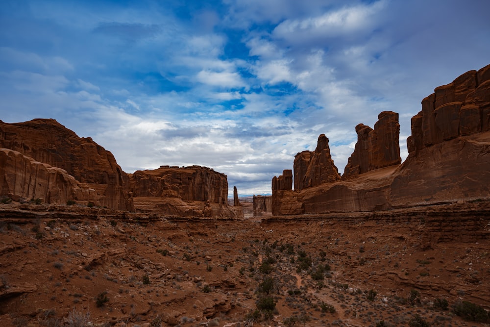 a desert landscape with rocks and a blue sky