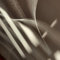 Dynamic light casting intricate patterns on a continuously changing 3D form.