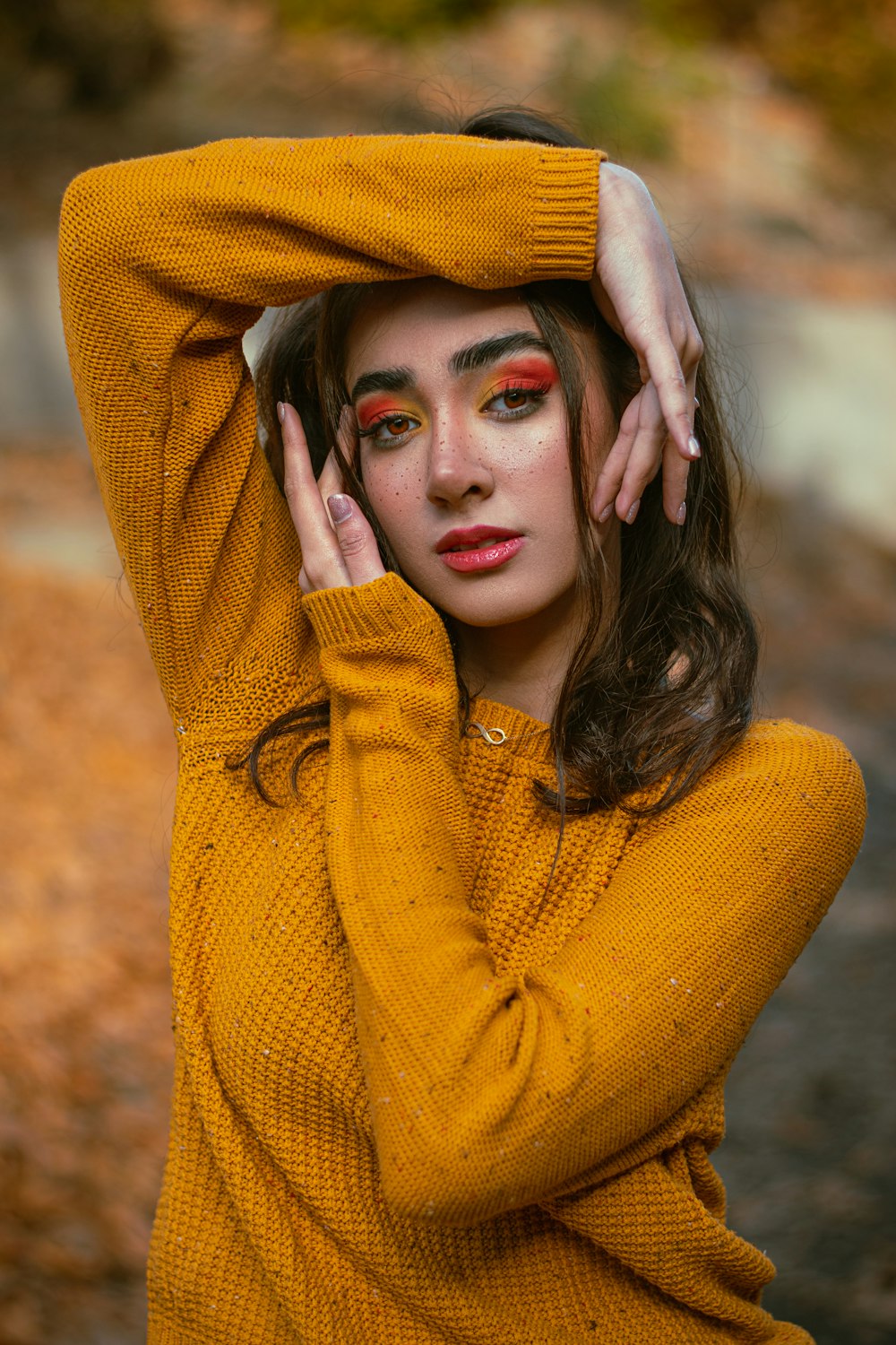 a woman in a yellow sweater is posing for a picture